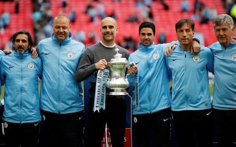 Pep Guardiola and his coaching staff - Credit: REUTERS