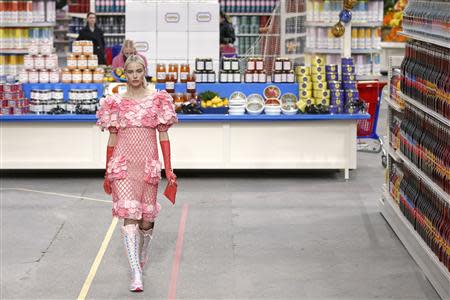 A model presents a creation by German designer Karl Lagerfeld as part of his Fall/Winter 2014-2015 women's ready-to-wear collection for French fashion house Chanel at the Grand Palais transformed into a "Chanel Shopping Center" during Paris Fashion Week March 4, 2014. REUTERS/Benoit Tessier