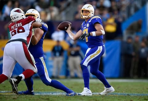 Los Angeles Chargers quarterback Philip Rivers, right, throws against the Arizona Cardinals during the second half of an NFL football game - Credit: AP Photo/Kelvin Kuo