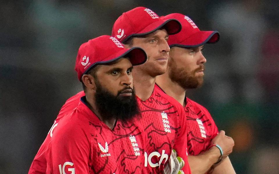 England's captain Jos Buttler, center, and teammates leave the field after their loss in the second T20 cricket match against Bangladesh in Dhaka - AP/Aijaz Rahi
