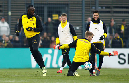 Soccer Football - Usain Bolt participates in a training session with Borussia Dortmund - Strobelallee Training Centre, Dortmund, Germany - March 23, 2018 Borussia Dortmund's Nuri Sahin and Usain Bolt during training REUTERS/Thilo Schmuelgen