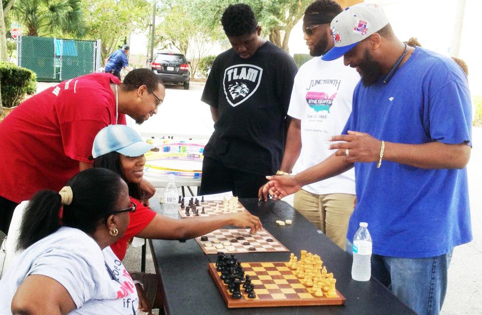 Attendees play chess and checkers at the seventh annual Juneteenth commemoration in Jacksonville in 2019.