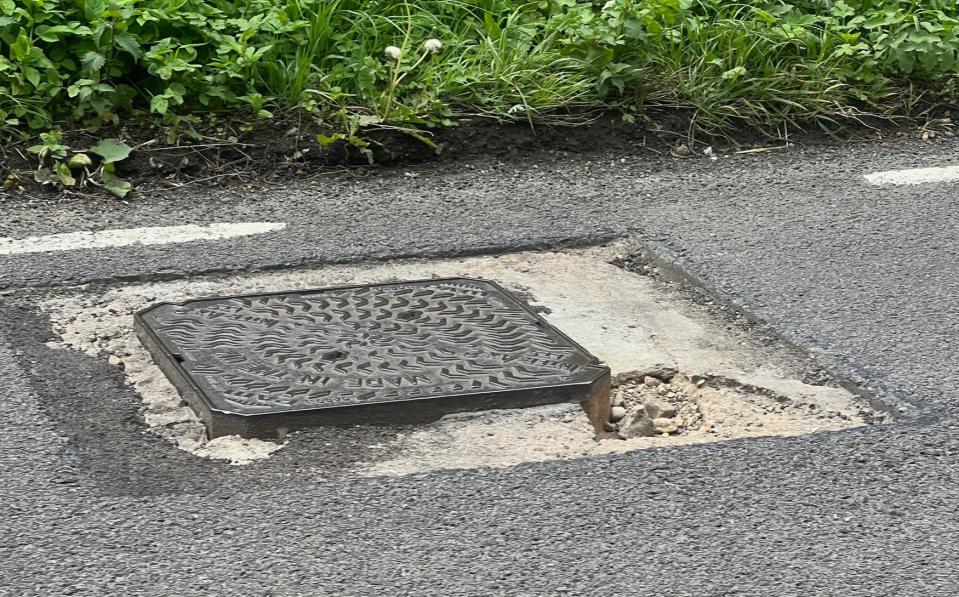 Metal ironwork is clearly protruding from the road surface near the accident