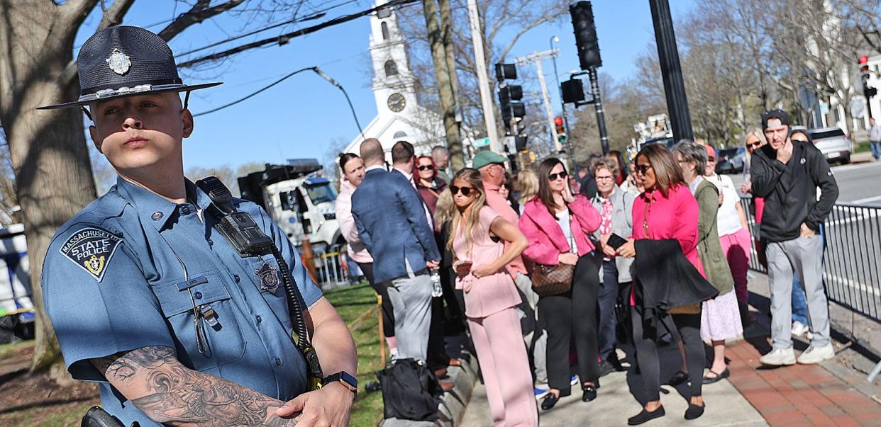 A state trooper watches spectators until they can enter the Norfolk Superior Court in Dedham for the start of jury selection in the murder trial of Karen Read on Tuesday, April 16, 2024.