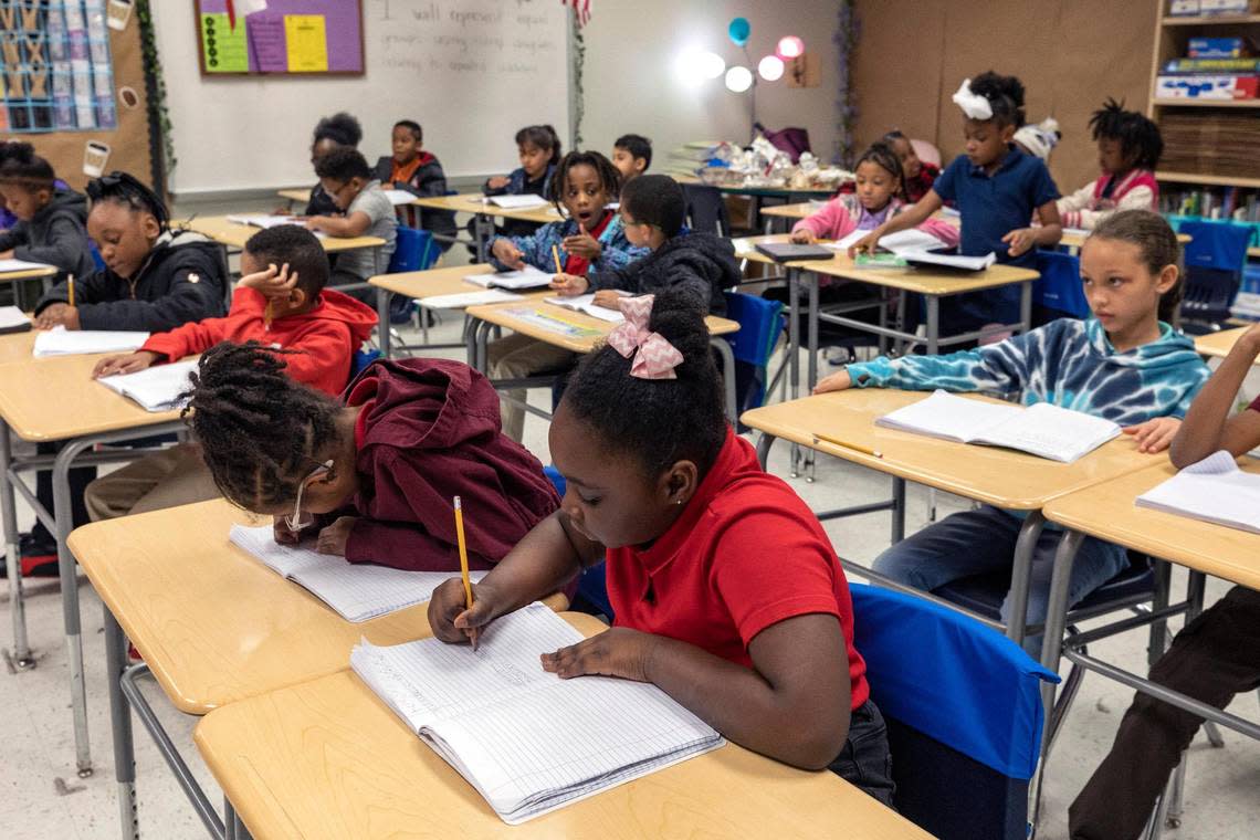 Second-grade students take notes during class at David L. Walker Elementary on Feb. 7.