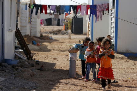 Syrian refugee children play near their families residence at Al Zaatari refugee camp, in the Jordanian city of Mafraq, near the border with Syria, November 29, 2015. REUTERS/ Muhammad Hamed