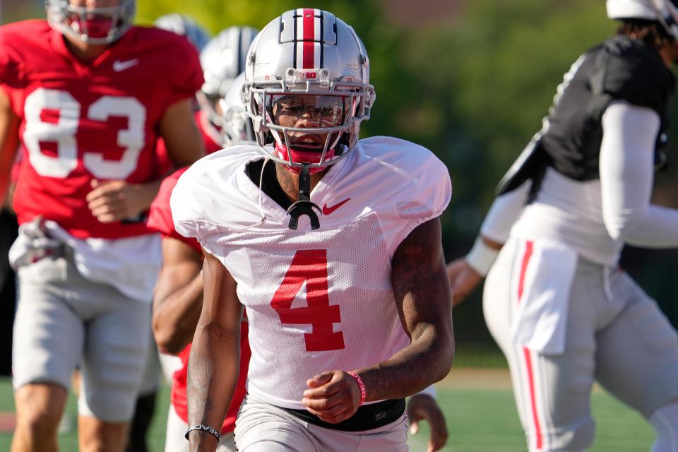 Aug 11, 2022; Columbus, OH, USA;  Ohio State Buckeyes cornerback JK Johnson (4) stretches during football camp at the Woody Hayes Athletic Center. Mandatory Credit: Adam Cairns-The Columbus Dispatch