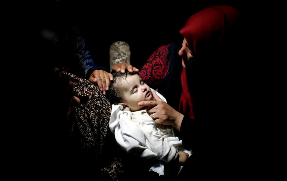 &nbsp;A relative mourns as she carries the body of eight-month-old Palestinian infant Laila al-Ghandour, who died after inhaling tear gas during a protest against U.S embassy move to Jerusalem at the Israel-Gaza border, during her funeral in Gaza City.&nbsp;