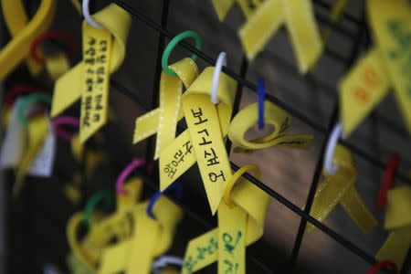 Yellow ribbons dedicated to the victims of the Sewol ferry disaster are seen hung on a fence in central Seoul November 11, 2014. REUTERS/Kim Hong-Ji