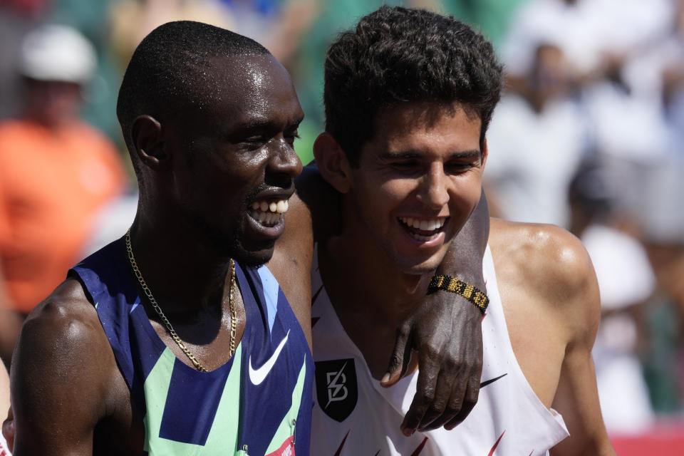 Paul Chelimo, left, celebrates with Grant Fisher after winning the finals of men's 5000-meter run at the U.S. Olympic Track and Field Trials Sunday, June 27, 2021, in Eugene, Ore. (AP Photo/Ashley Landis)