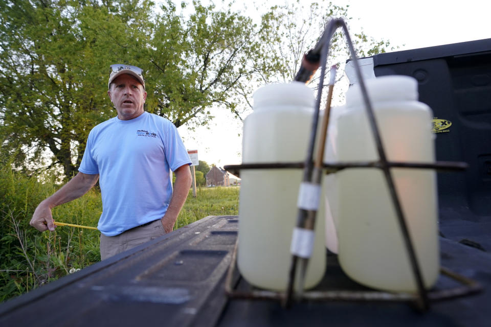 Des Moines Water Works employee Bill Blubaugh looks over water samples taken from the Raccoon River, Thursday, June 3, 2021, in Des Moines, Iowa. Each day the utility analyzes samples from the Raccoon River and others from the nearby Des Moines River as it works to deliver drinking water to more than 500,000 people in Iowa's capital city and its suburbs. (AP Photo/Charlie Neibergall)