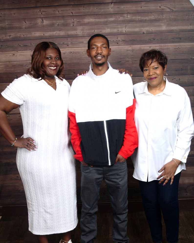 Jayland Walker stands next to his sister and mother.