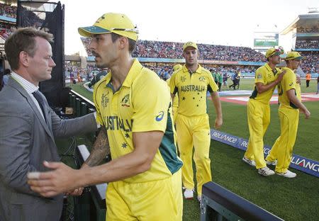 Australia's Mitchell Johnson (2nd L) gets a handshake as he leaves the field after losing to New Zealand during their Cricket World Cup match in Auckland, February 28, 2015. REUTERS/Nigel Marple