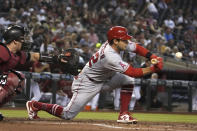 Los Angeles Angels' David Fletcher lays down an RBI sacrifice bunt against the Arizona Diamondbacks in the first inning during a baseball game, Sunday, June 13, 2021, in Phoenix. (AP Photo/Rick Scuteri)