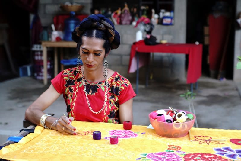 Estrella Vasquez, a muxe woman who features on the cover of Vogue magazine, paints a Huipil at her house in Juchitan