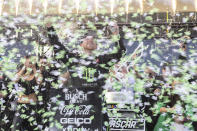 Tyler Reddick, center, celebrates after winning a NASCAR Cup Series auto race at Circuit of the Americas, Sunday, March 26, 2023, in Austin, Texas. (AP Photo/Stephen Spillman)