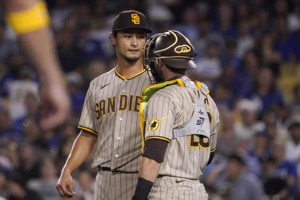 San Diego Padres starting pitcher Yu Darvish, left, talks with catcher Austin Nola during the third inning of a baseball game against the Los Angeles Dodgers Friday, Sept. 2, 2022, in Los Angeles. (AP Photo/Mark J. Terrill)