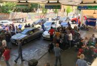 Cars queue for fuel at a gas station in Beirut