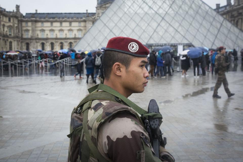 A French soldier patrols in the courtyard of the Louvre museum in Paris, Saturday, Feb. 4, 2017. The Louvre in Paris reopened to the public Saturday morning, less than 24-hours after a machete-wielding assailant shouting "Allahu Akbar!" was shot by soldiers, in what officials described as a suspected terror attack. (AP Photo/Kamil Zihnioglu)