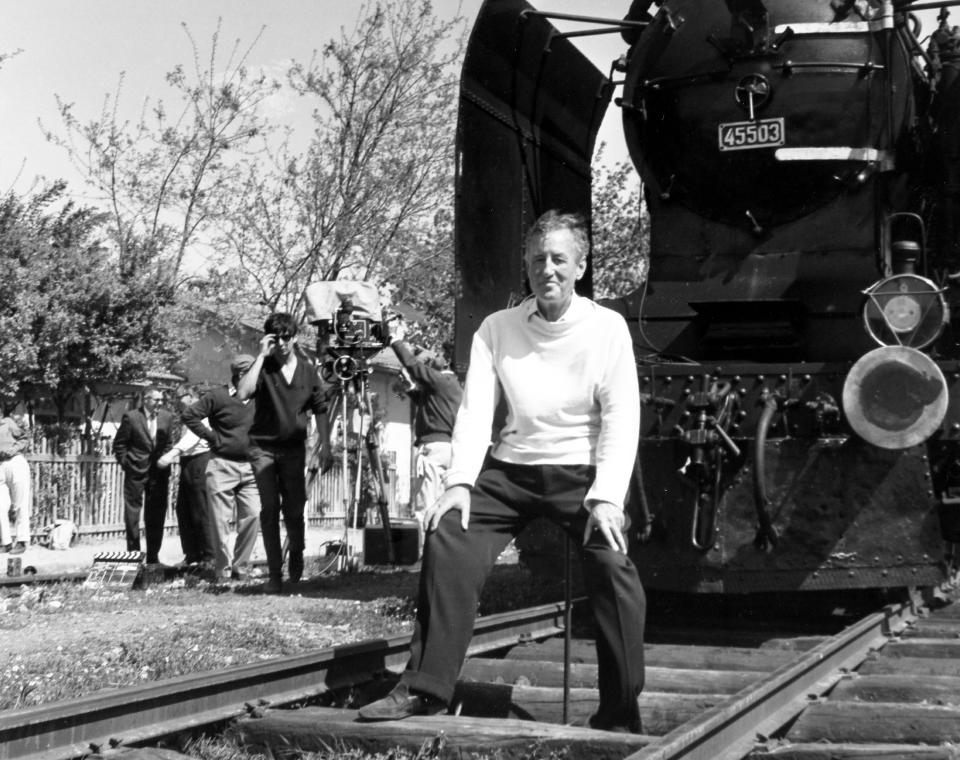 FILE - In this June 23, 1963 file photo, British writer Ian Fleming, author of the James Bond spy thrillers, sits in front of a Turkish train, as a gag, during a visit to the set of the film 