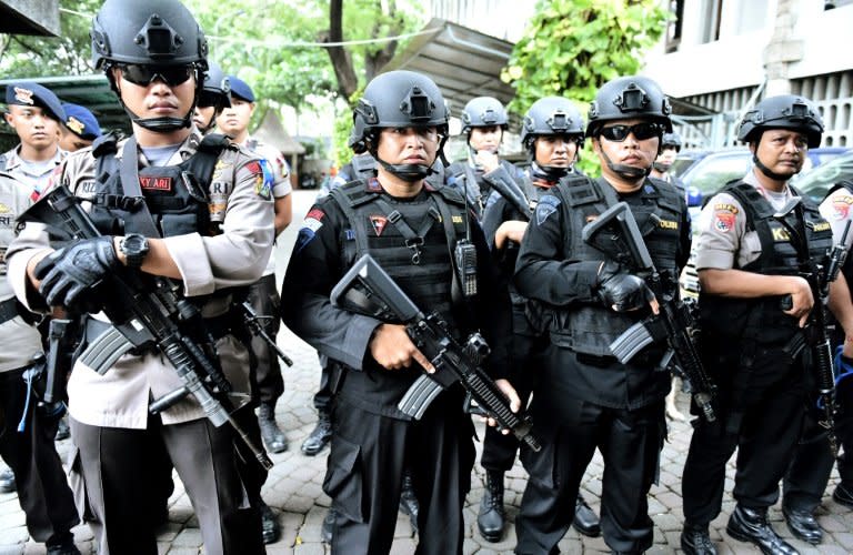 Indonesian police guard a checkpoint in Jakarta