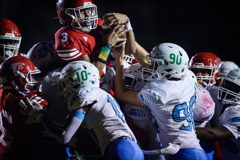 Seventy-First's Anthony Quinn Jr. gets lifted into the air and pushed into the end zone for a touchdown during the first quarter against J.H. Rose in second round of high school football playoffs on Thursday, Nov. 10, 2022, at Seventy-First High School.