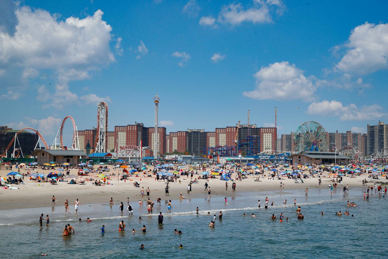 Revelers enjoy the beach at Coney Island in the Brooklyn borough of New York.