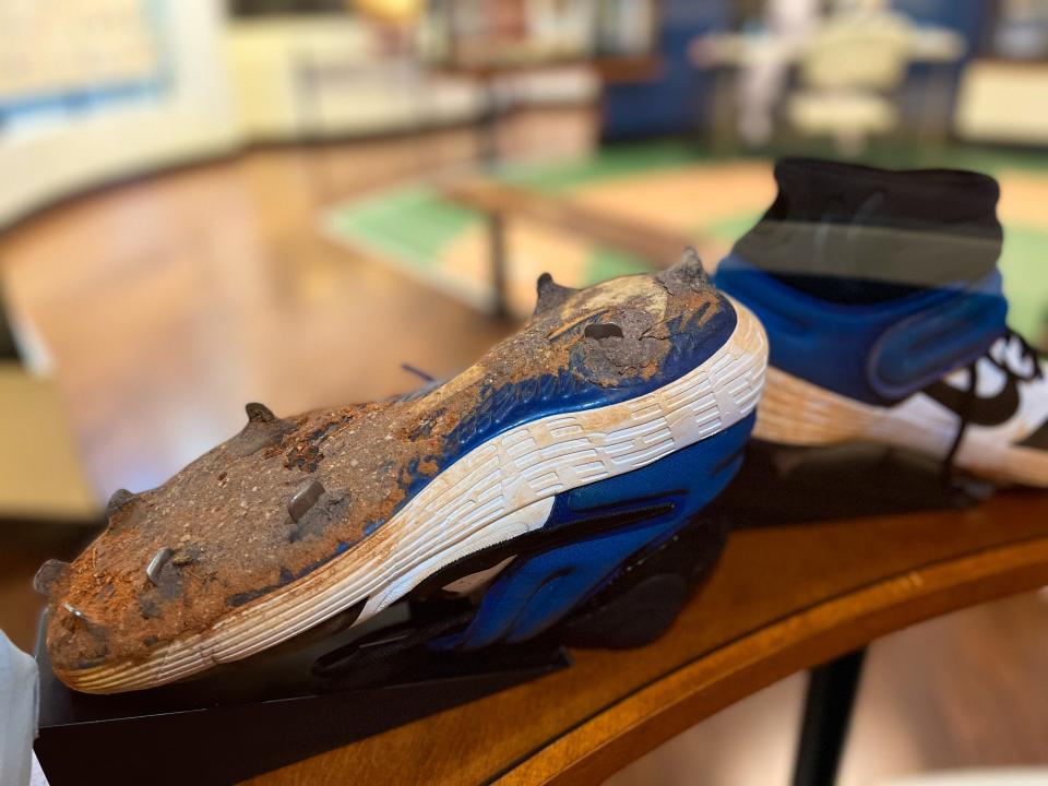 Pete Alonso's game-worn pair of cleats clogged with clay are displayed at the Tampa Baseball Museum. Alonso is first baseman for the New York Mets and a native of Tampa.