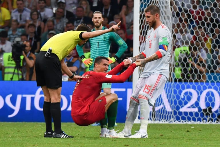 Ronaldo is helped up by Sergio Ramos, on a night that saw the Real Madrid club colleagues come up against one another