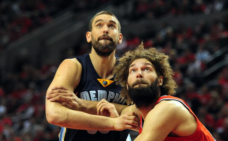 Marc Gasol (L) of the Memphis Grizzlies and Robin Lopez of the Portland Trail Blazers battle for position under the basket during Game 3 of the Western Conference quarter-finals, during the NBA Playoffs, at Moda Center in Portland, on April 25, 2015