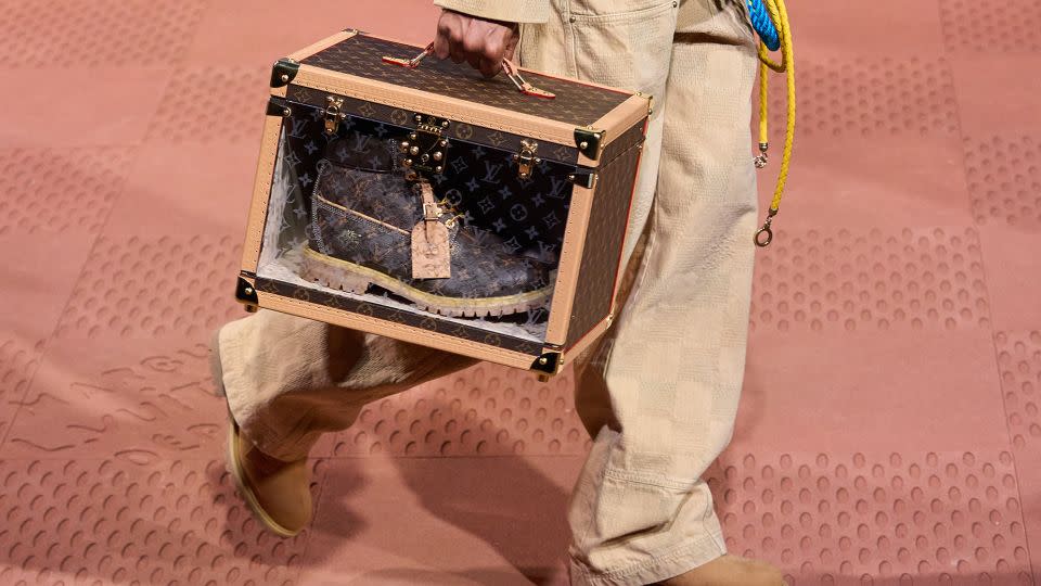 Vuitton will produce a limited-edition version of Timberland's six-inch boot in their signature monogram with 18-karat gold eyelets. Each pair comes  with it's own shoe trunk. - Francois Durand/Getty Images