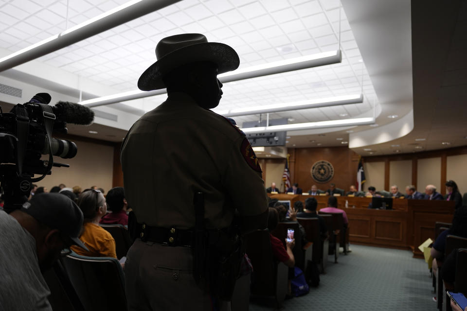 A Texas state trooper watches as a Texas House committee votes to take up a bill to limit the age for purchasing AR-15 style weapons in the full House in Austin, Texas, Monday, May 8, 2023. (AP Photo/Eric Gay)