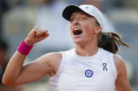 Poland's Iga Swiatek celebrates winning her semifinal match of the French Open tennis tournament of the French Open tennis tournament against Brazil's Beatriz Haddad Maia in two sets, 6-2, 7-6 (9-7),at the Roland Garros stadium in Paris, Thursday, June 8, 2023. (AP Photo/Christophe Ena)