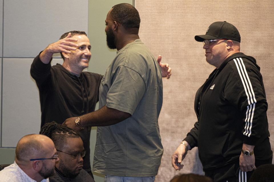 Philadelphia Eagles's Fletcher Cox embraces with General Manager Howie Roseman, left, on Tuesday, Apr 9, 2024, during his official retirement announcement at the NovaCare Complex in Philadelphia. (Jose F. Moreno/The Philadelphia Inquirer via AP)