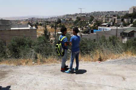 Palestinian school children chat outside a school in the East Jerusalem neighbourhood of Jabel Mukhaber June 12, 2017. Picture taken June 12, 2017. REUTERS/Ammar Awad