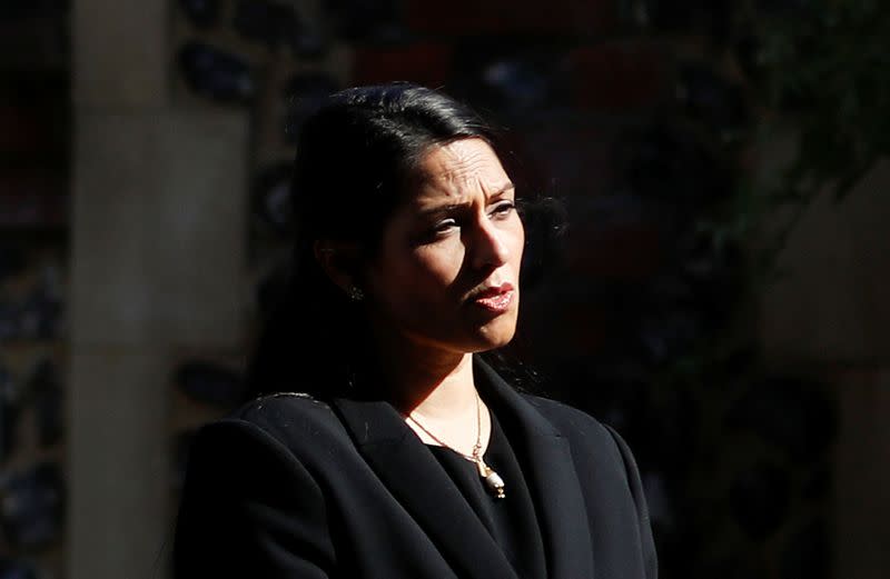 Britain's Home Secretary, Priti Patel, speaks to the media near to the scene of reported multiple stabbings in Reading