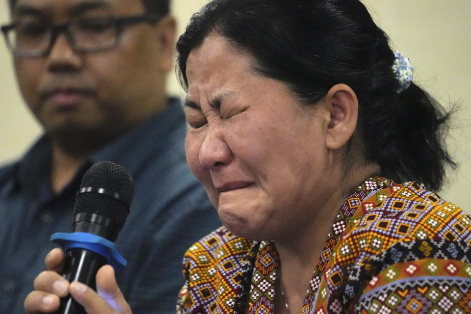Burmese Zing Raltu breaks into tears as she talks to reporters after filing a criminal complaint against Myanmar's top generals at the Department of Justice in Manila, Philippines on Wednesday Oct. 25, 2023. Relatives of victims of alleged war crimes committed by Myanmar’s military filed a criminal complaint in the Philippines against their nation’s ruling generals in a desperate attempt to test whether such a case could succeed outside the violence-wracked country.(AP Photo/Aaron Favila)