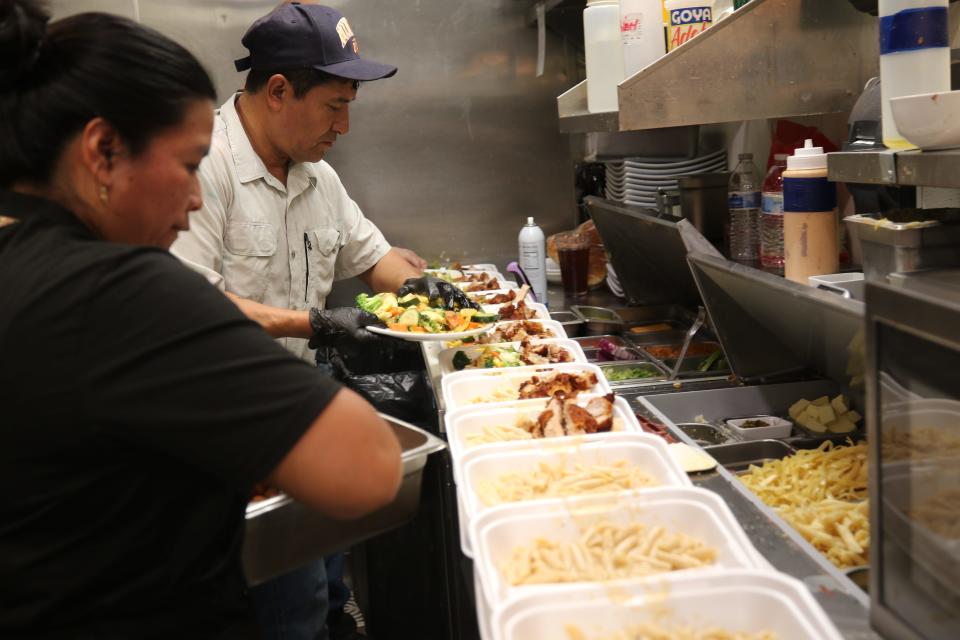 Kitchen staff prepare a large catering order, May 1, 2024 at Yellow Brix Restaurant in Carlsbad.