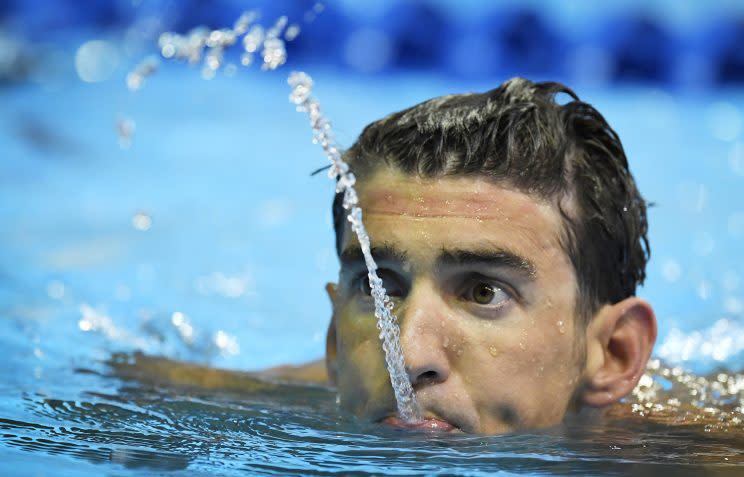 Michael Phelps spits water after swimming in the men's 200-meter individual medley preliminaries at the U.S. Olympic swimming trials, June 30, 2016, in Omaha, Neb. (Photo: Mark J. Terrill/AP)