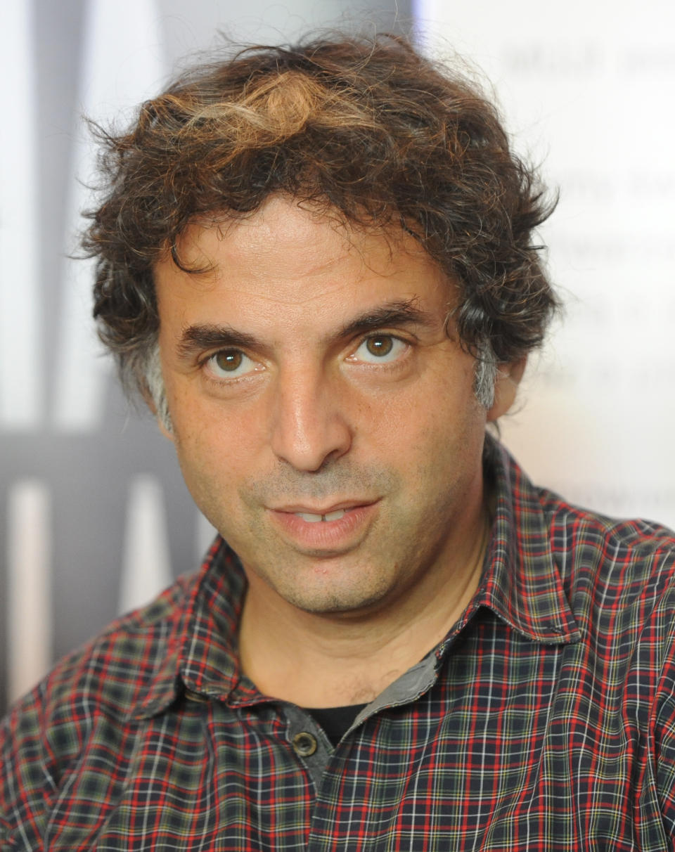 Israeli writer  Etgar Keret speaks during a press conference one day ahead of the official opening of one of the world’s narrowest houses, in Warsaw, Poland, Friday, Oct. 19, 2012. The two-level “Keret’s House” is no wider than 122 centimeters (48.03 inches) and was fitted into tiny space puzzlingly left between a pre-war house and a modern apartment block of the 1960s in downtown Warsaw. It is named after Etgar Keret, an Israeli writer of Polish roots who will be the first inhabitant of this artistic project of aluminum and polycarbonate. (AP Photo/Alik Keplicz)