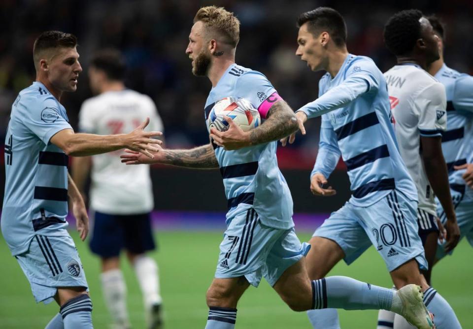 Sporting Kansas City’s Remi Walter, from left to right, Johnny Russell and Daniel Salloi celebrate Russell’s goal during a recent match in Vancouver, Canada.