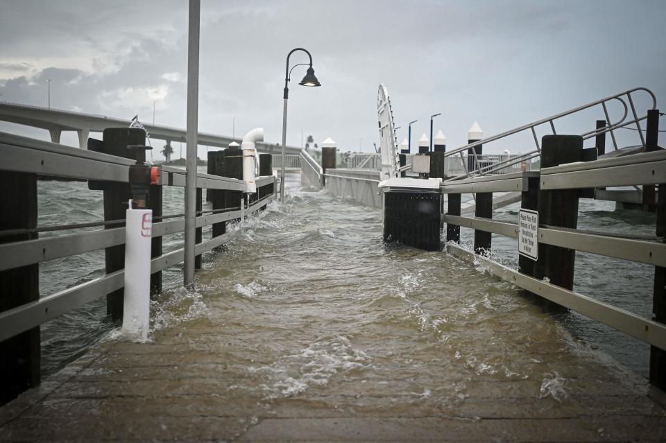 A boardwalk at the Clearwater Harbor Marina in Clearwater, Florida, is flooded by the rising tide on Aug. 30, 2023, after Hurricane Idalia made landfall. MIGUEL J. RODRIGUEZ CARRILLO, AFP via Getty Images)