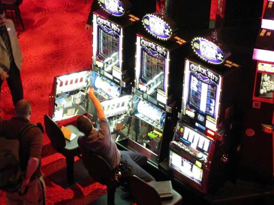 In this March 28, 2012, photo, a worker fixes some slot machines that malfunctioned at Revel, the Atlantic City N.J., casino resort that had its first trial run the same day. The resort opens to the public on Monday, April 2. (AP Photo/Wayne Parry)