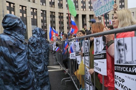 People attend a rally to demand authorities allow opposition candidates to run in a local election in Moscow