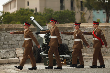 Members of the Royal Gibraltar Regiment march after firing a 21-gun salute to mark the 92nd birthday of Britain's Queen Elizabeth II, in front of the Rock, in the British overseas territory of Gibraltar, historically claimed by Spain, April 21, 2018. REUTERS/Jon Nazca