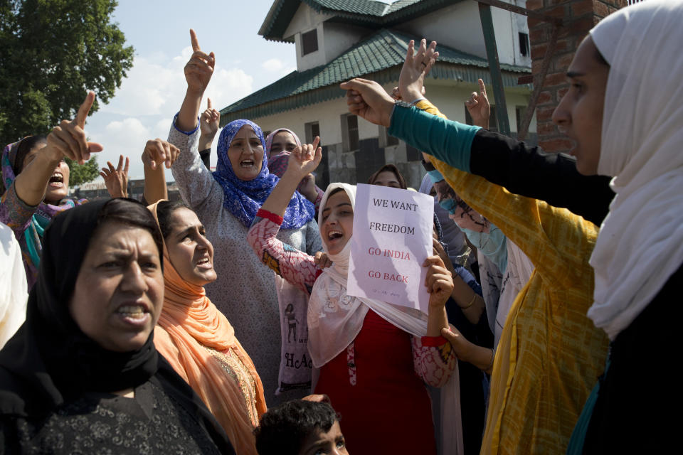 Kashmiri Muslim women shout slogans during a protest after Eid prayers in Srinagar, Indian controlled Kashmir, Monday, Aug. 12, 2019. Troops in India-administered Kashmir allowed some Muslims to walk to local mosques alone or in pairs to pray for the Eid al-Adha festival on Monday during an unprecedented security lockdown that still forced most people in the disputed region to stay indoors on the Islamic holy day. (AP Photo/ Dar Yasin)