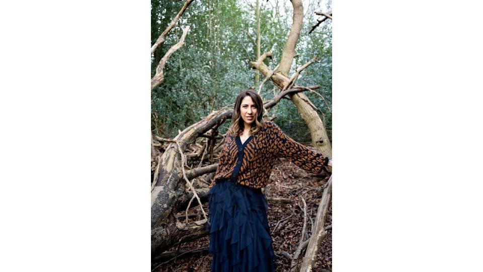 Woman in the woods in patterned cardigan