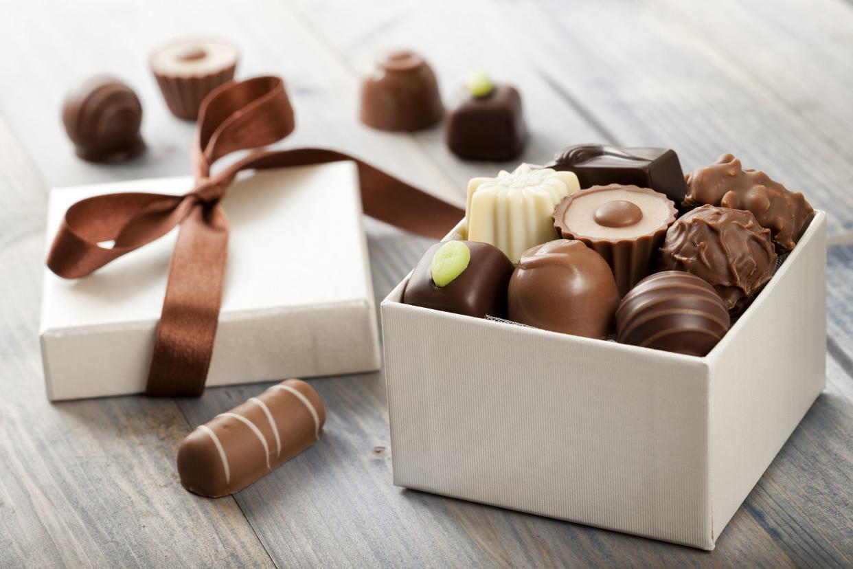 Box of assorted chocolates on a wood table