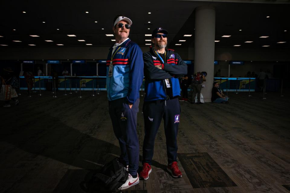 Cosplayers dressed as "Ted Lasso" soccer coaches.