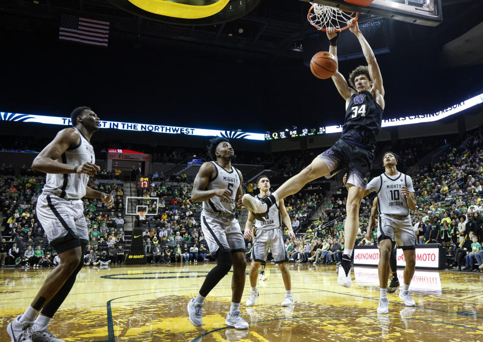 Washington center Braxton Meah (34) dunks against Oregon during the second half of an NCAA college basketball game in Eugene, Ore., Thursday, Feb. 8, 2024. (AP Photo/Thomas Boyd)